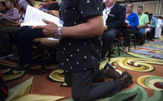 A delegate prays Sept. 23, 2018, during the Fifth National Encuentro in Grapevine, Texas. (CNS/Tyler Orsburn)