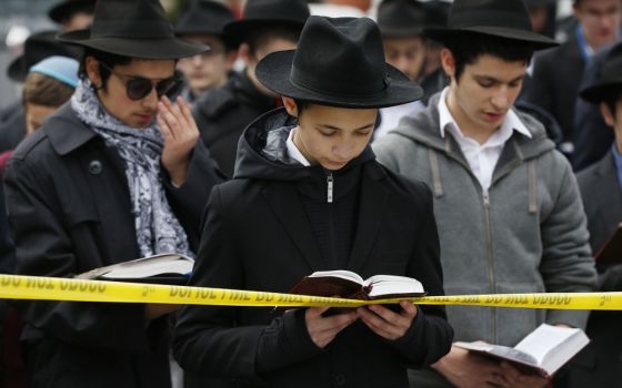 Students from the Yeshiva School pray in front of the Tree of Life synagogue Oct. 29, two days after a mass shooting at the Pittsburgh synagogue. (CNS/EPA/Jared Wickerham)