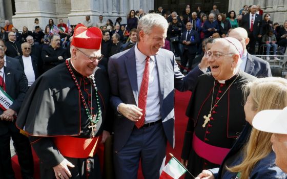 New York City Mayor Bill de Blasio shares a light moment with New York Cardinal Timothy Dolan, left, and Bishop Nicholas DiMarzio of Brooklyn, New York, outside St. Patrick's Cathedral during the Columbus Day Parade in New York City Oct. 14, 2019. (CNS)