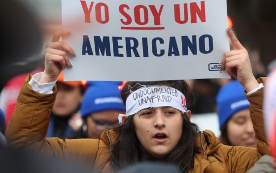 A demonstrator holds a sign outside the U.S. Supreme Court in Washington Nov. 12 as justices hear arguments in a legal challenge to the Trump administration's bid to end the Deferred Action for Childhood Arrivals program. (CNS/Reuters/Jonathan Ernst)