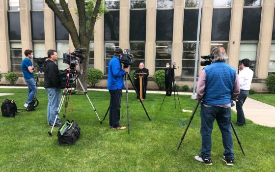 Archbishop Bernard Hebda of St. Paul-Minneapolis speaks to media May 21 outside the Archdiocesan Catholic Center in St. Paul, Minnesota. Standing behind the archbishop is Auxiliary Bishop Andrew Cozzens. (CNS/The Catholic Spirit/Tom Halden)