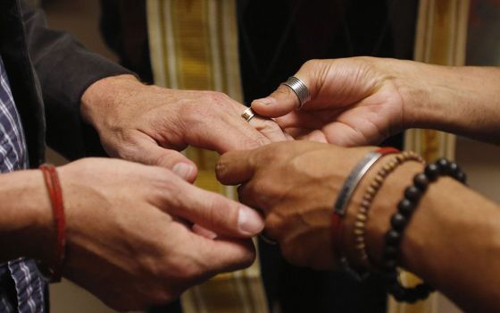 A same-sex couple is pictured in a file photo exchanging rings during a ceremony in Salt Lake City. In a new documentary, Pope Francis expressed openness to the idea of laws recognizing civil unions, including for gay couples, to protect their rights. (CN