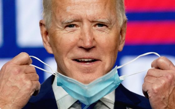 Joe Biden removes his face mask to speak about the presidential election results during an appearance in Wilmington, Delaware, Nov. 4. (CNS/Reuters/Kevin Lamarque)