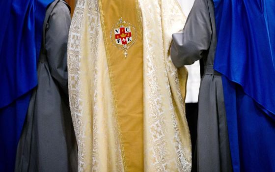 Sisters of the Servants of the Lord and the Virgin of Matara help then-Cardinal Theodore McCarrick walk through Holy Comforter-St. Cyprian Catholic Church in Washington after the ceremony for their profession of vows Nov. 1, 2017, in Washington. (CNS/Tyle