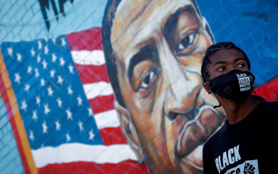 A person in the Brooklyn borough of New York City attends a birthday vigil for George Floyd Oct. 14. Floyd was pinned down May 25 and died at the hands of a Minneapolis police officer. (CNS/Brendan McDermid, Reuters)