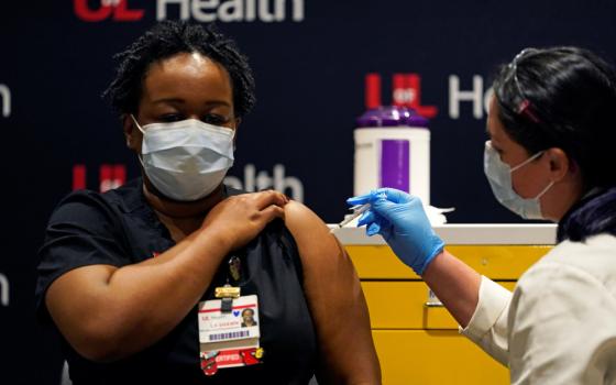 LaShawn Scott, a nurse at University of Louisville Hospital, is inoculated with the Pfizer coronavirus vaccine at the Louisville, Kentucky, health care facility Dec. 14. (CNS/Reuters/Bryan Woolston)