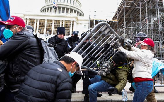 Law enforcement officers push back against supporters of President Donald Trump attempting to enter the U.S. Capitol in Washington Jan. 6, 2020, during a protest against the certification of the 2020 presidential election. (CNS/Jim Urquhart, Reuters)