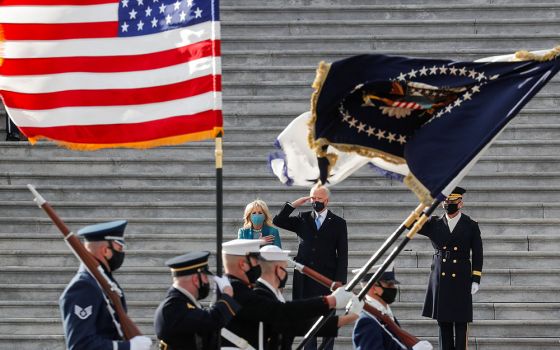 President Joe Biden and first lady Jill Biden review the readiness of military troops in a pass-in-review ceremony at the U.S. Capitol Jan. 20 in Washington. (CNS/Mike Segar, Reuters)