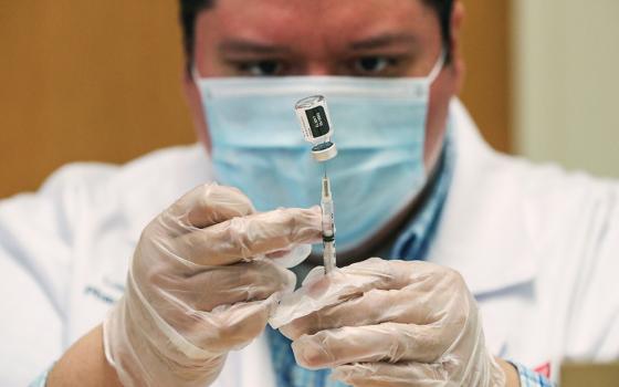 A Walgreens health care professional prepares a dose of the Pfizer-BioNTec COVID-19 vaccine Feb. 22 in Evanston, Illinois. (CNS/Kamil Krzaczynski, Reuters)