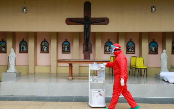 A health care makes rounds at a Catholic church training center turned into a self-isolation shelter for COVID-19 patients in Jakarta, Indonesia, July 22, 2021. (CNS photo/Ajeng Dinar Ulfiana, Reuters)