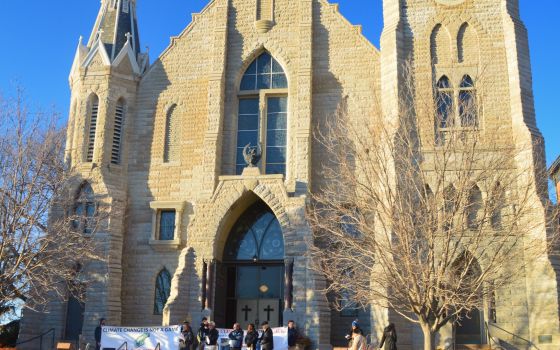 Students and others gather on the steps of St. John Church on the Creighton University campus in Omaha, Neb., Feb. 20, 2020, for a prayerful rally to call on school leaders to divest from fossil fuels. (CNS photo/courtesy Emily Burke)