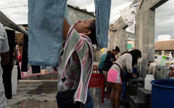 Asylum-seeking migrants from Central America do their laundry in the public square of Reynosa, Mexico, Aug. 27, 2021. (CNS photo/Go Nakamura, Reuters)