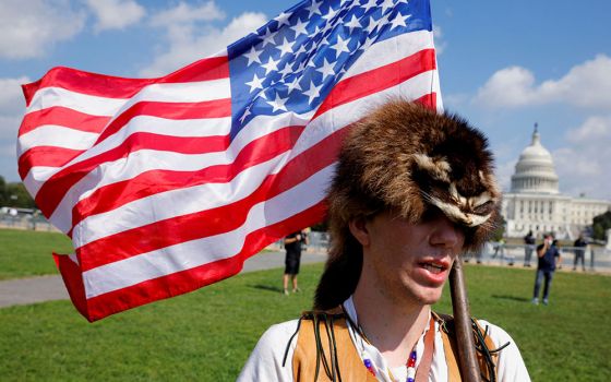 A man in Washington wearing a raccoon hat Sept. 18 talks about how he believes former President Donald Trump won the 2020 election but it was stolen from him through fraud.