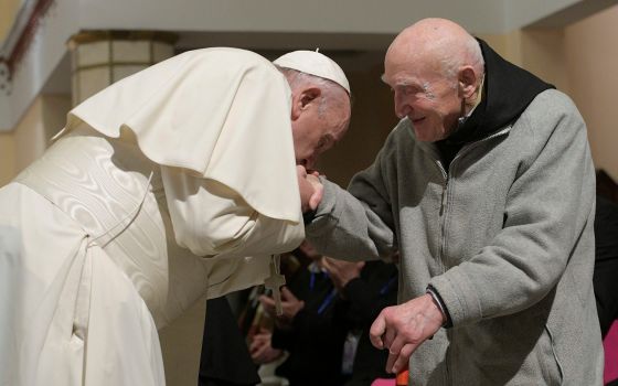 In this photo Pope Francis kisses Father Schumacher's hand during a meeting at the cathedral in Rabat, Morocco, March 31, 2019. (CNS photo/Vatican Media)