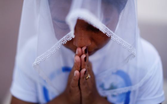 A woman is pictured in a file photo praying at St. Anthony church in Yangon, Myanmar. (CNS photo/Jorge Silva, Reuters)