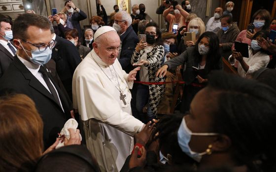 Pope Francis greets people as he leaves an ecumenical prayer with migrants in the Church of the Holy Cross Dec. 3 in Nicosia, Cyprus, Dec. 3. (CNS/Paul Haring)