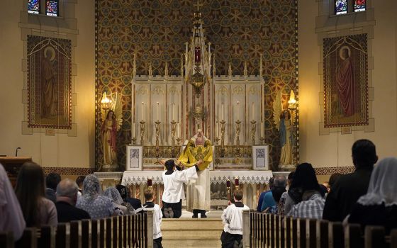 Fr. Stephen Saffron, parish administrator, elevates the Eucharist during a Tridentine Mass at St. Josaphat Church in the Queens borough of New York City in this July 18 file photo. (CNS/Gregory A. Shemitz)