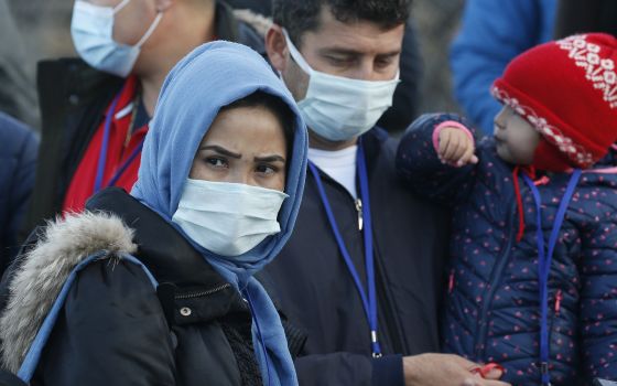 Family members wait to enter an event with Pope Francis at the government-run Reception and Identification Center for refugees in Mytilene, Greece, Dec. 5, 2021. (CNS photo/Paul Haring)