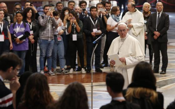 Pope Francis prepares to address young people who participated in a pilgrimage hike from the Monte Mario nature reserve in Rome to St. Peter's Basilica at the Vatican Oct. 25, 2018, during the Synod of Bishops on young people, the faith and vocational discernment. Catholic young people are among the many groups of the faithful worldwide invited to share testimony and talk abut their experience of church during preparations for the 2023 world Synod of Bishops on synodality. (CNS photo/Paul Haring)