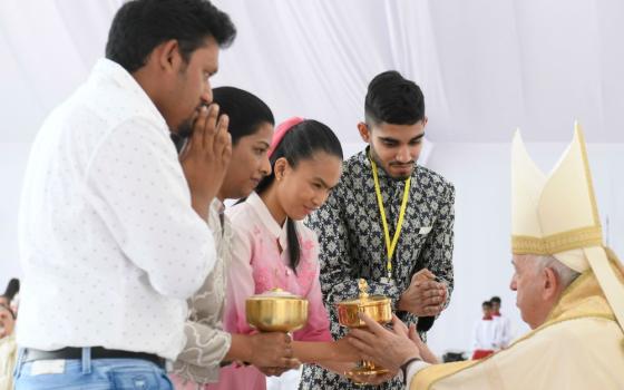 Pope receives gifts during Mass in Bahrain.