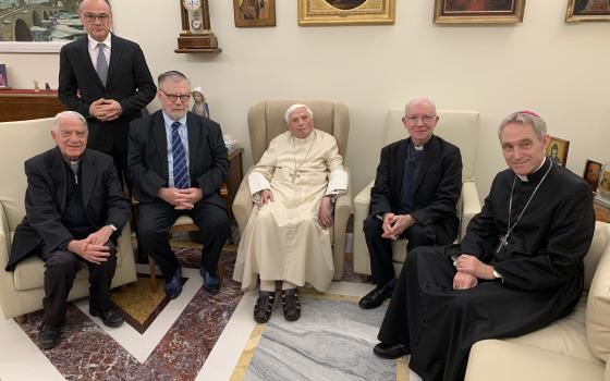 Retired Pope Benedict XVI sits with Ratzinger Prize winners Joseph H. H. Weiler, professor of law at New York University School of Law, and Jesuit Father Michel Fédou, professor of dogmatic and patristic theology at the Centre Sèvres in Paris, during a visit to the Mater Ecclesia monastery at the Vatican on Dec. 1, 2022. Also seated are Jesuit Father Federico Lombardi, president of the foundation, and Archbishop Georg Gänswein, Pope Benedict's private secretary. (CNS photo/courtesy of Joseph Ratzinger-Vatic