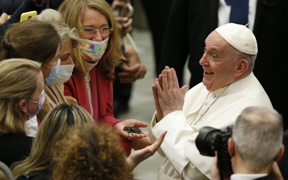 Pope Francis gestures as he greets people during his general audience in the Paul VI hall at the Vatican Jan. 5, 2022. (CNS photo/Paul Haring)