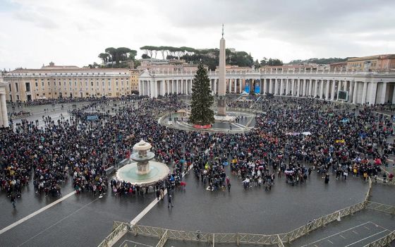 People in St. Peter's Square attend the Angelus led by Pope Francis from the window of his studio overlooking the square at the Vatican Jan. 6, the feast of the Epiphany. (CNS/Vatican Media)