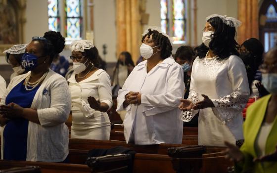 Members of the Ladies Auxiliary of the Knights of Peter Claver pray during a Mass marking Black Catholic History Month Nov. 21, 2021, at Our Lady of Victory Church in the Bedford-Stuyvesant section of Brooklyn, N.Y. (CNS photo/Gregory A. Shemitz)