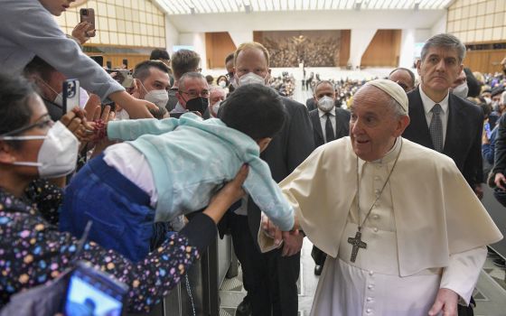 Pope Francis greets a child during his general audience in the Paul VI hall at the Vatican Feb. 23, 2022. (CNS photo/Paul Haring)