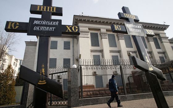 Crosses installed during a protest against Russia's actions in eastern Ukraine are pictured Feb. 23 in front of the Russian Embassy in Kyiv, Ukraine. The signs on the crosses read: "Russian occupier." (CNS/Reuters/Valentyn Ogirenko)