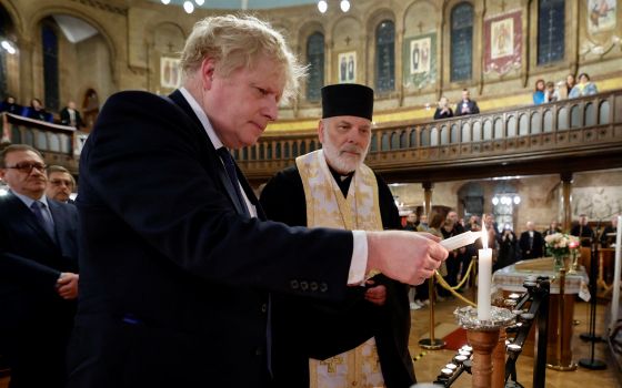 British Prime Minister Boris Johnson attends a prayer service with Bishop Kenneth Nowakowski, head of the Ukrainian Catholic Diocese of the Holy Family in London, at the Ukrainian Catholic cathedral in London Feb. 27, 2022. (CNS photo/Jamie Lorriman, Pool