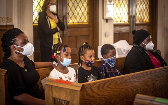 A family attends Mass at St. Barbara Catholic Church in Philadelphia Feb. 6. (CNS/Chaz Muth)