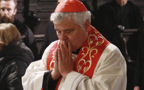 Cardinal Konrad Krajewski, the papal almoner, prays during an interreligious prayer service in the Latin-rite cathedral of Lviv, Ukraine