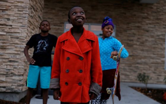 Children from Congo who have received refugee status in the U.S. stand outside a temporary hotel residence in Boise, Idaho, Oct. 29, 2021