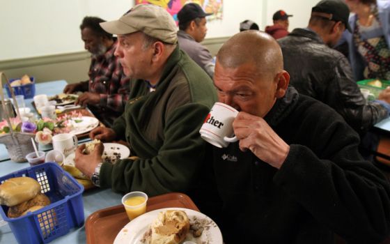 Men are pictured in a file photo eating a free meal in the cafeteria of a Franciscan-run soup kitchen in the Park Slope section of Brooklyn, N.Y. The U.N.'s celebration of World Food Day is Oct. 16