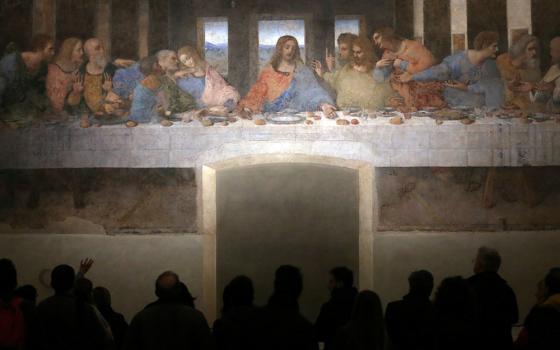 Visitors look at Leonardo da Vinci's "The Last Supper" on a refectory wall at Santa Maria delle Grazie Church in Milan. (CNS/Reuters/Stefano Rellandini)