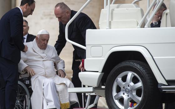 Pope Francis is assisted at the end of his general audience in leaving St. Peter's Square at the Vatican March 29, 2023.