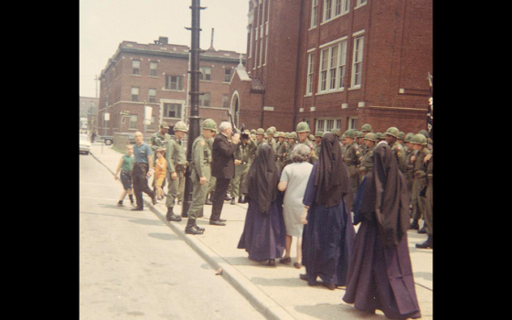 Then-Archbishop John Dearden of Detroit talks with troops stationed outside St. Rose of Lima Church on Detroit's east side as a group of Catholic sisters listens nearby during the 1967 unrest. Dearden launched a three-year synodal process that took place in Detroit, culminating in its 1969 diocesan synod. (CNS/Archdiocese of Detroit Archives)