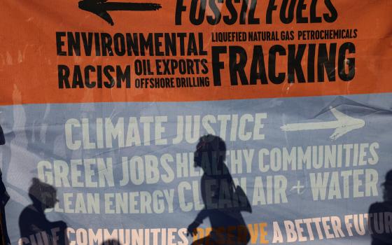 Environmental activists protest outside the White House in Washington June 30, 2021, to demand U.S. President Joe Biden stop fossil fuel projects and put climate justice at the heart of his infrastructure plans. (CNS/Reuters/Evelyn Hockstein) 