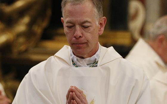 Archbishop Alexander Sample of Portland, Oregon, returns to his seat after receiving Communion during Mass at the Basilica of St. John Lateran in Rome Feb. 4, 2020. (CNS/Paul Haring)