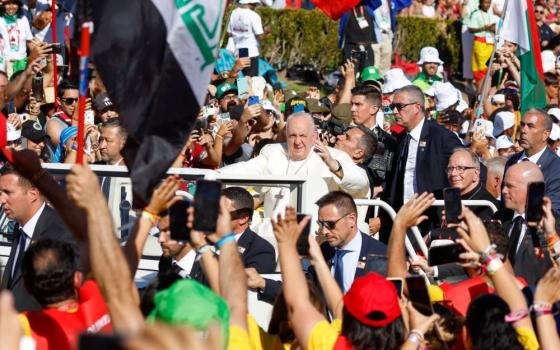 Young people cheer as Pope Francis arrives in the popemobile for the World Youth Day Stations of the Cross with young people at Eduardo VII Park in Lisbon, Portugal, Aug. 4. (CNS/Lola Gomez)