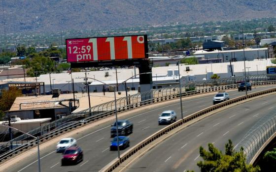 A digital billboard displays an unofficial temperature, July 17, 2023, in downtown Phoenix. Millions of people around the Southwest are living through a historic heat wave. (AP Photo/Matt York)