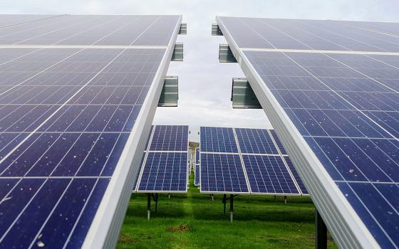 Rows of solar panels on a solar farm. (Unsplash/Creative Commons/Mariana Proença)