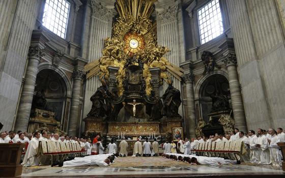 New deacons from the Pontifical North American College lie prostrate during their ordination in St. Peter's Basilica Sept. 29, 2022, at the Vatican. In Episode 3 of "The Vatican Briefing," Bishop Shane Mackinlay, a member of the synod's Commission for the Synthesis Report, expresses openness to ordaining women as Catholic deacons. (CNS photo/Paul Haring)