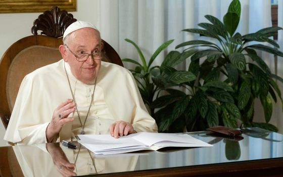 Pope Francis smiles after delivering his speech by video from the Vatican to religious leaders attending the inauguration of the Faith Pavilion at the U.N. climate change conference Dec. 3 in Dubai, United Arab Emirates. Pope Francis canceled his trip to Dubai because of a bronchial infection. (CNS/Vatican Media)