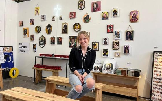 Gracie Morbitzer, artist and editor behind the new book "Modern Saints: Portraits and Reflections on the Saints," poses in her studio. 