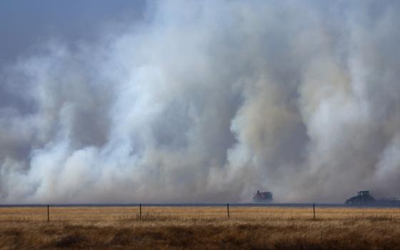 Smoke gather in field.