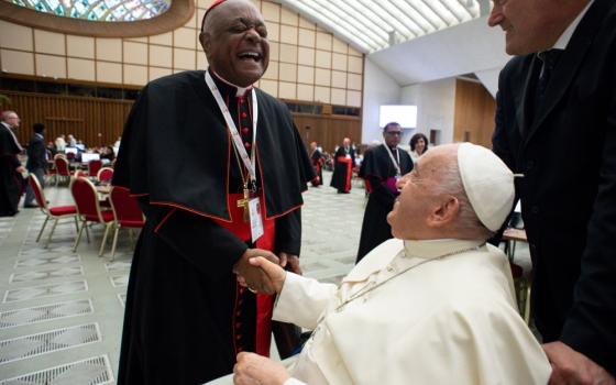 Cardinal Wilton Gregory of Washington and Redemptorist Fr. Vimal Tirimanna of Sri Lanka work during a break at the assembly of the Synod of Bishops in the Vatican's Paul VI Audience Hall Oct. 10.