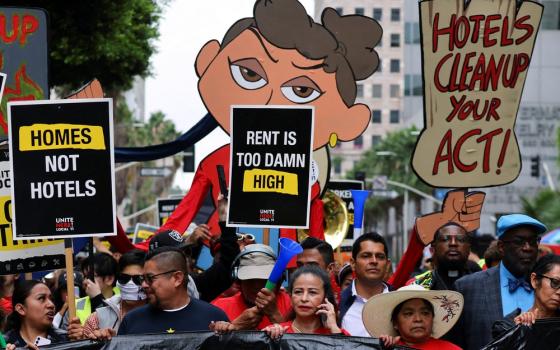 Strikers hold signs in street.