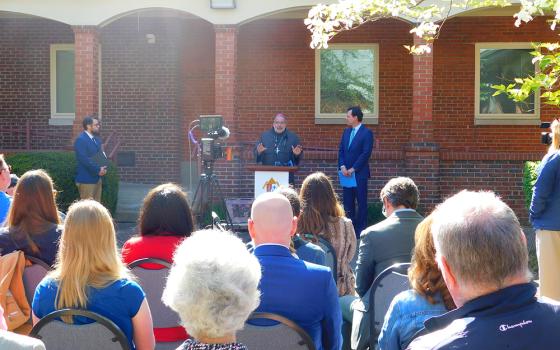 Bishop John Stowe of the Diocese of Lexington, Kentucky, at a press conference April 23 announces a net-zero initiative to make the Lexington Diocese one of the first in America to adopt such a commitment. At right is Adam Edelen, founder and CEO of Edelen Renewables. At left is Joshua van Cleef, director of the diocese's peace and justice office. (Courtesy of Diocese of Lexington)